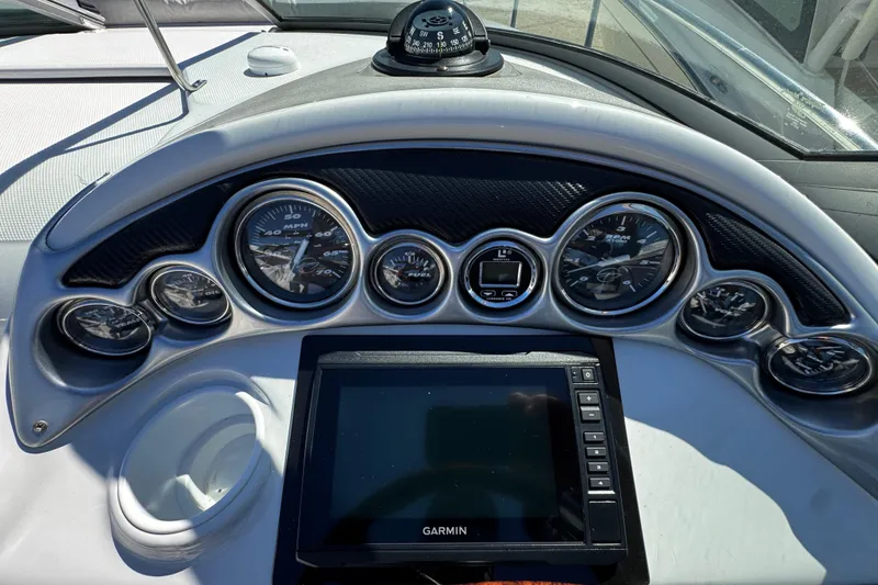 Slide: The Image of Interior view of a 2004 Crownline 250 CR boat, featuring sleek seating and a polished surface. - 73