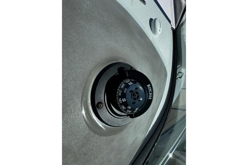 Slide: The Image of 2004 Crownline 250 CR boat interior with white seating and a small table. - 74