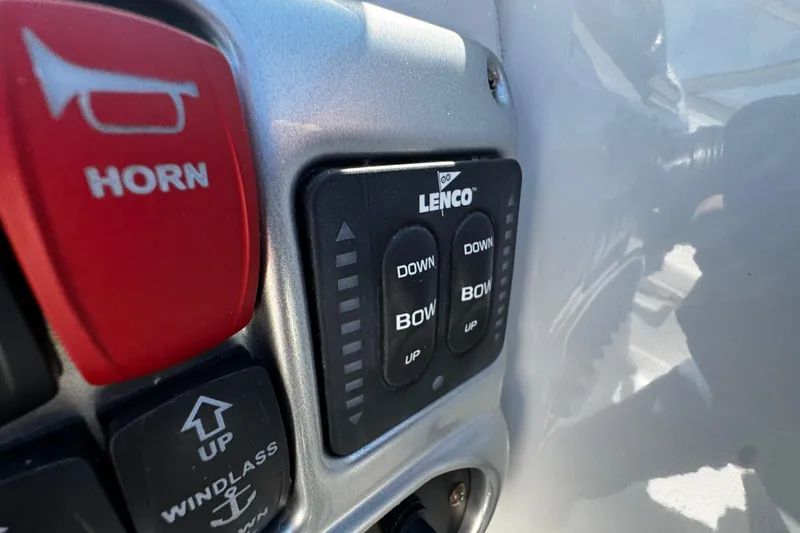 Slide: The Image of 2004 Crownline 250 CR boat cockpit with white leather seats and modern dashboard. - 75