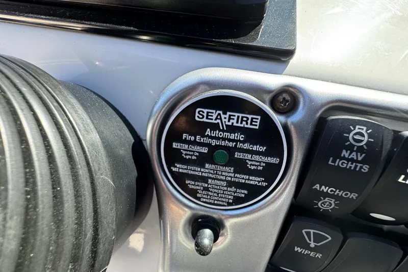 Slide: The Image of 2004 Crownline 250 CR boat interior with white seating and dashboard controls. - 76