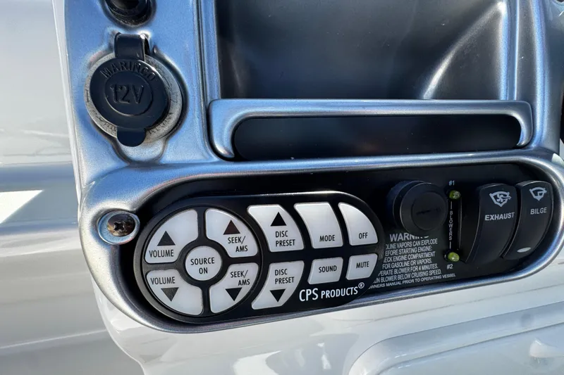 Slide: The Image of 2004 Crownline 250 CR boat interior with white leather seating and steering wheel. - 77