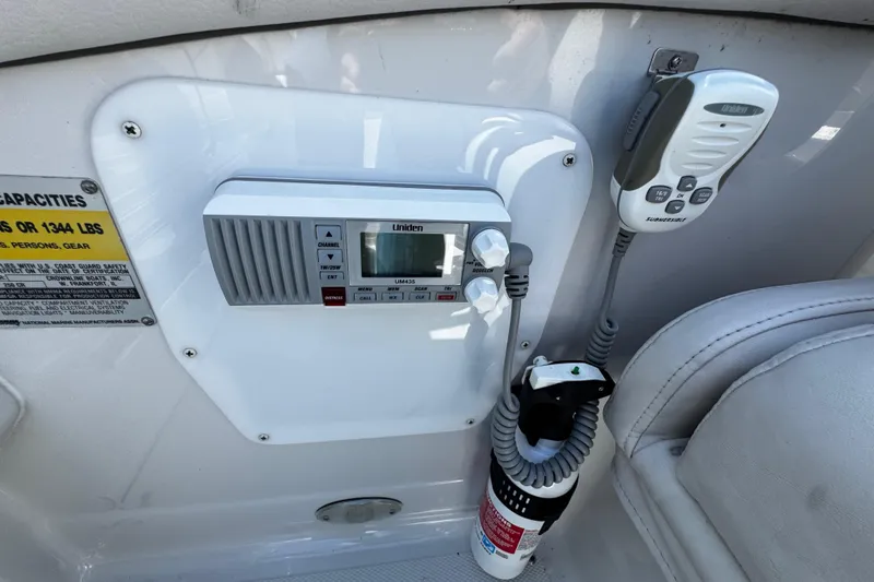 Slide: The Image of 2004 Crownline 250 CR boat dashboard with wood-accented steering wheel and instrument panel. - 79