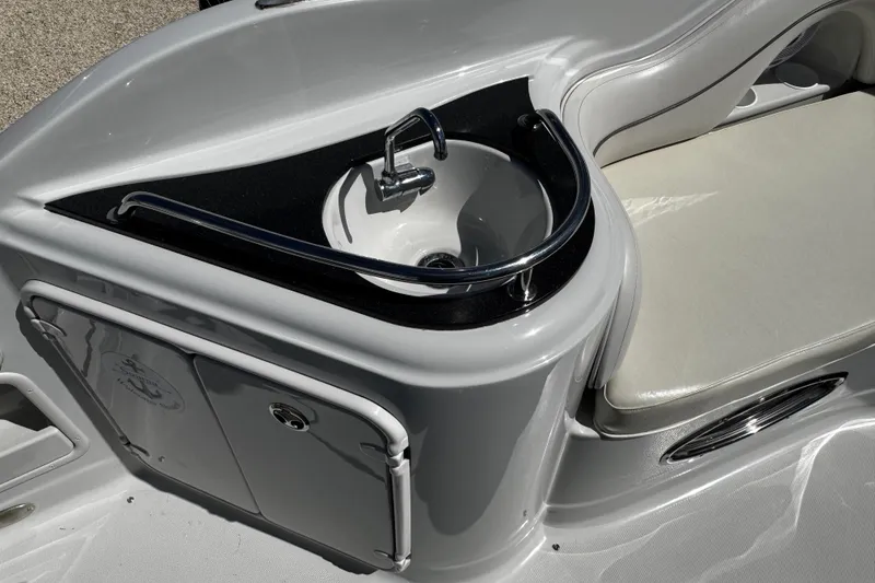 Slide: The Image of 2004 Crownline 250 CR boat dashboard with Uniden radio and fire extinguisher. - 86