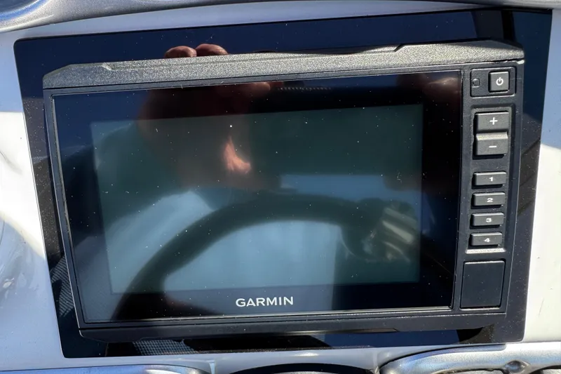 Slide: The Image of 2004 Crownline 250 CR boat dashboard with steering wheel and controls. - 88