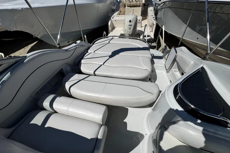 Slide: The Image of 2004 Crownline 250 CR boat interior with sink and seating area. - 93