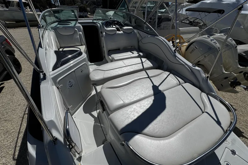 Slide: The Image of 2004 Crownline 250 CR boat interior with seating and table setup. - 94