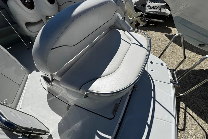 Slide: The Image of 2004 Crownline 250 CR boat interior with white seating and table. - 96