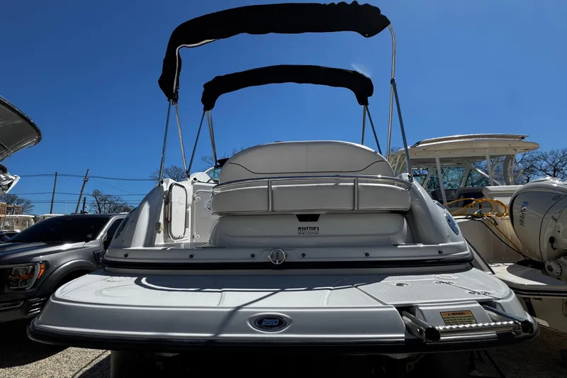 Slide: The Image of 2004 Crownline 250 CR boat interior with white seating and table. - 97