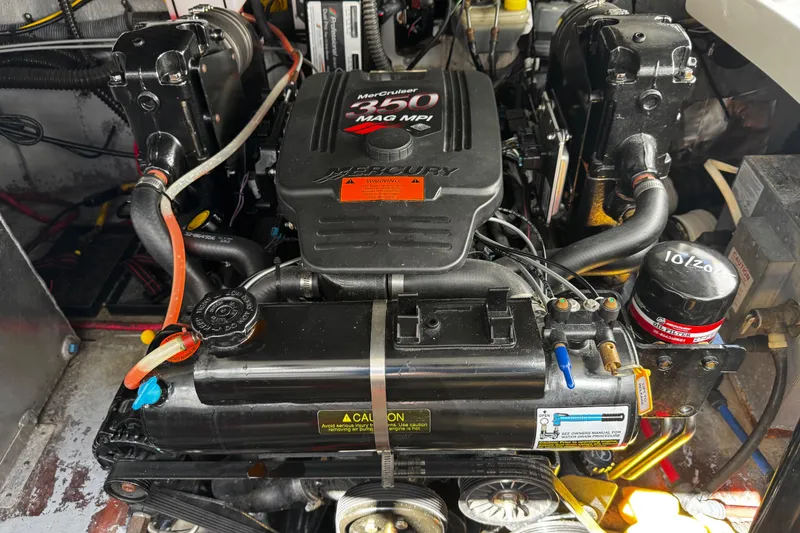 Slide: The Image of 2004 Crownline 250 CR boat interior with gray seating and storage compartments. - 98