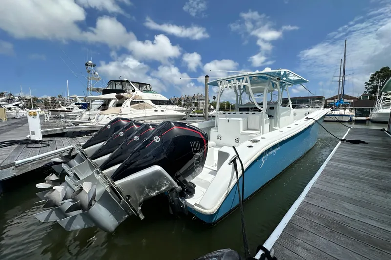 The Image of 2009 Yellowfin 42 Offshore boat docked with multiple outboard engines. - 0