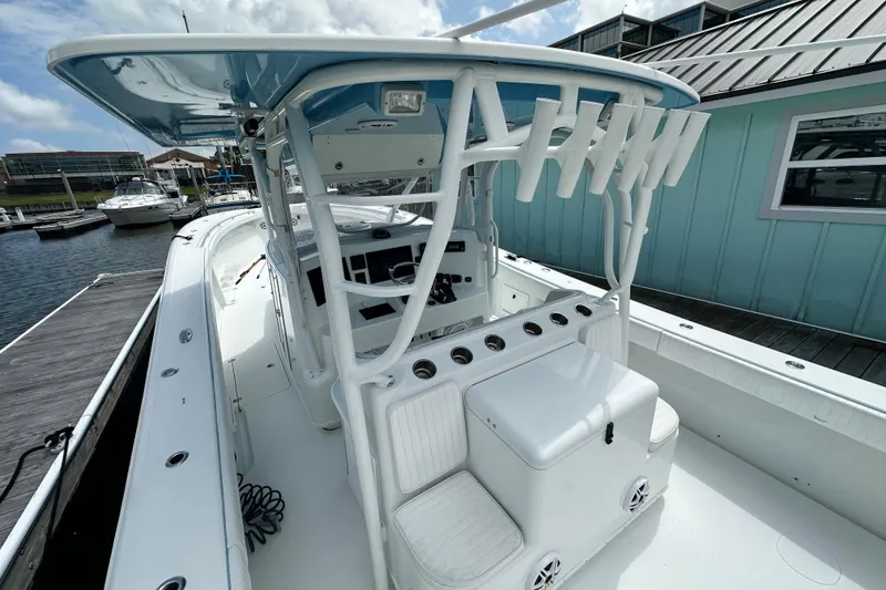 Slide: The Image of 2009 Yellowfin 42 Offshore boat docked, featuring spacious deck and modern helm station. - 12