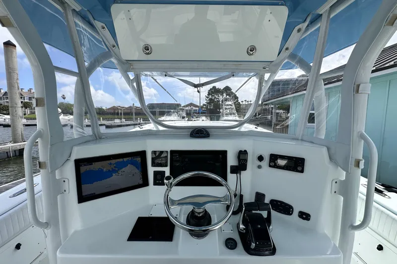 Slide: The Image of 2009 Yellowfin 42 Offshore boat helm with navigation equipment and steering wheel. - 17