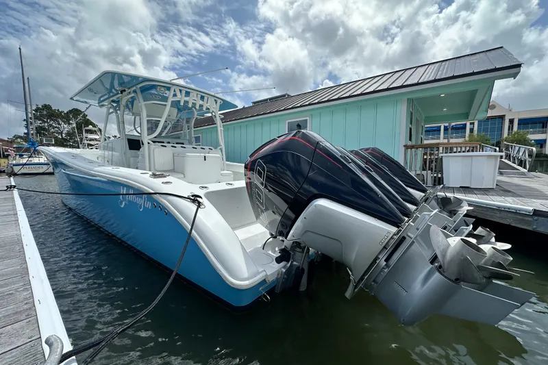 Slide: The Image of 2009 Yellowfin 42 Offshore boat docked with triple outboard engines. - 2
