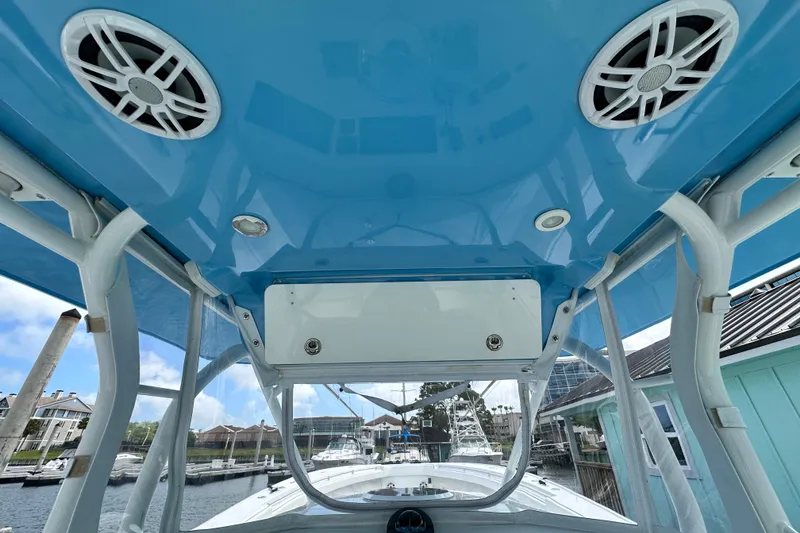 Slide: The Image of Interior view of a 2009 Yellowfin 42 Offshore boat with blue ceiling and speakers. - 21