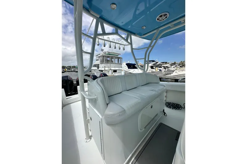 Slide: The Image of 2009 Yellowfin 42 Offshore boat interior with cushioned seating at marina. - 23