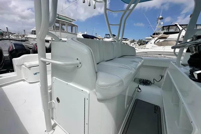 Slide: The Image of 2009 Yellowfin 42 Offshore boat interior with white seating at marina. - 24