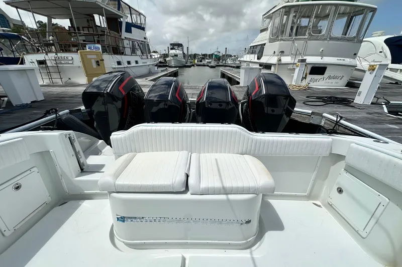 Slide: The Image of 2009 Yellowfin 42 Offshore boat with four powerful outboard engines docked at a marina. - 29