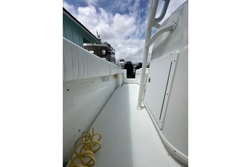 Slide: The Image of 2009 Yellowfin 42 Offshore boat deck with white seating and storage compartment. - 31