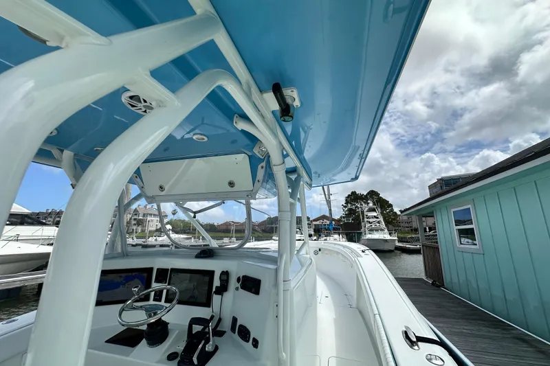Slide: The Image of 2009 Yellowfin 42 Offshore boat interior with steering wheel and navigation screens. - 33