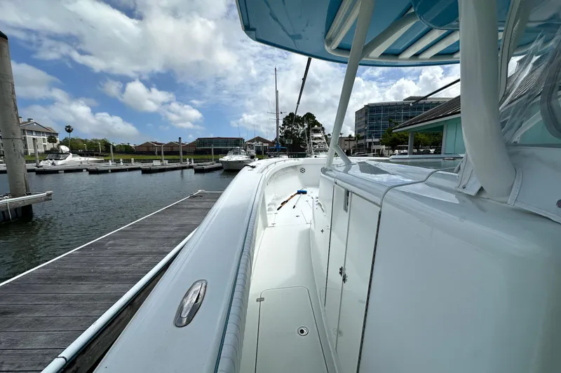 Slide: The Image of 2009 Yellowfin 42 Offshore boat docked at marina under cloudy sky. - 34