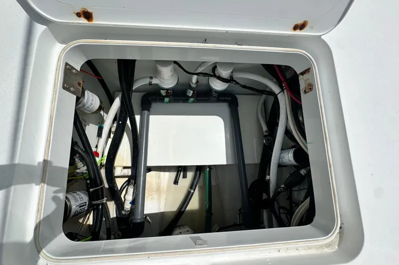 Slide: The Image of 2009 Yellowfin 42 Offshore boat compartment with visible wiring and plumbing. - 35