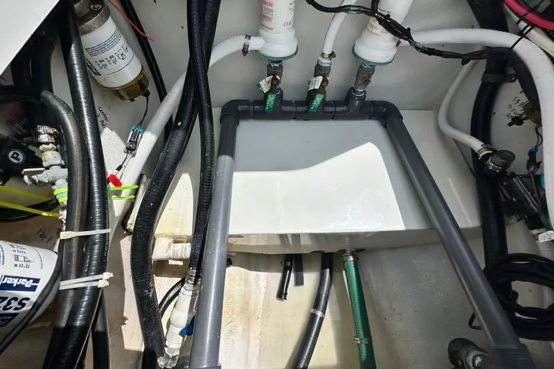 Slide: The Image of Engine compartment of a 2009 Yellowfin 42 Offshore boat, showing hoses and fittings. - 37