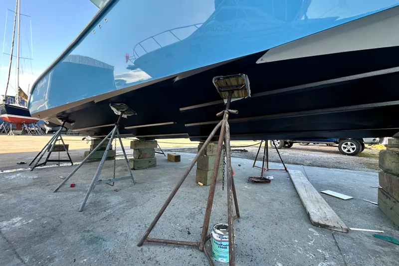 Slide: The Image of 2009 Yellowfin 42 Offshore boat on stands, undergoing maintenance in a shipyard. - 4