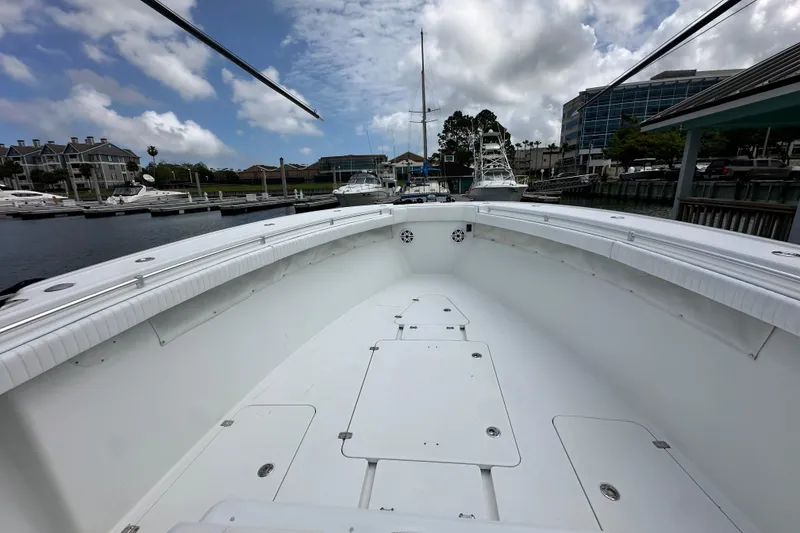Slide: The Image of 2009 Yellowfin 42 Offshore boat docked at marina under cloudy sky. - 48