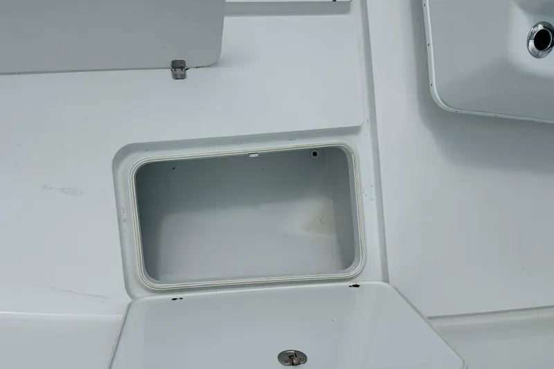 Slide: The Image of Storage compartment on a 2009 Yellowfin 42 Offshore boat, featuring a clean, white interior. - 54