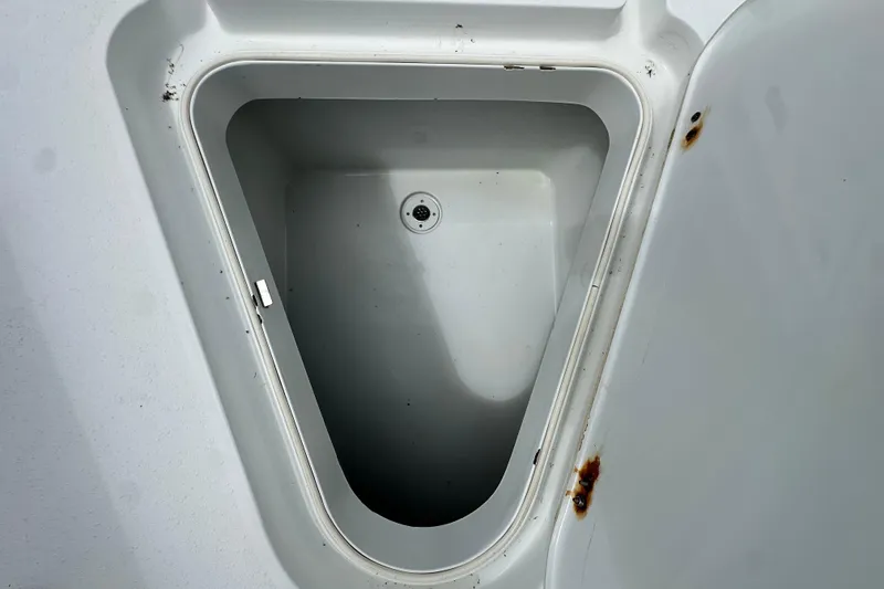 Slide: The Image of Open storage compartment on a 2009 Yellowfin 42 Offshore boat, showing interior details. - 55