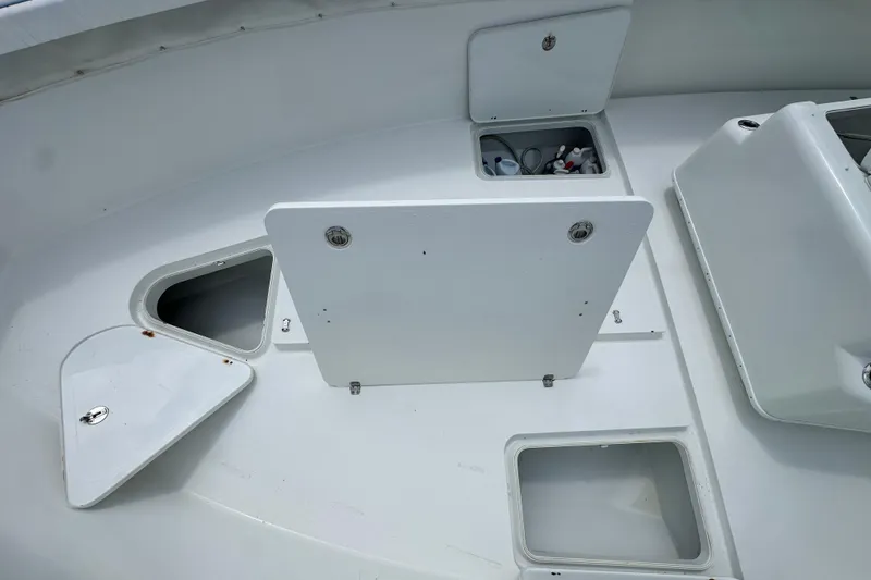 Slide: The Image of 2009 Yellowfin 42 Offshore boat deck with open storage compartments. - 56