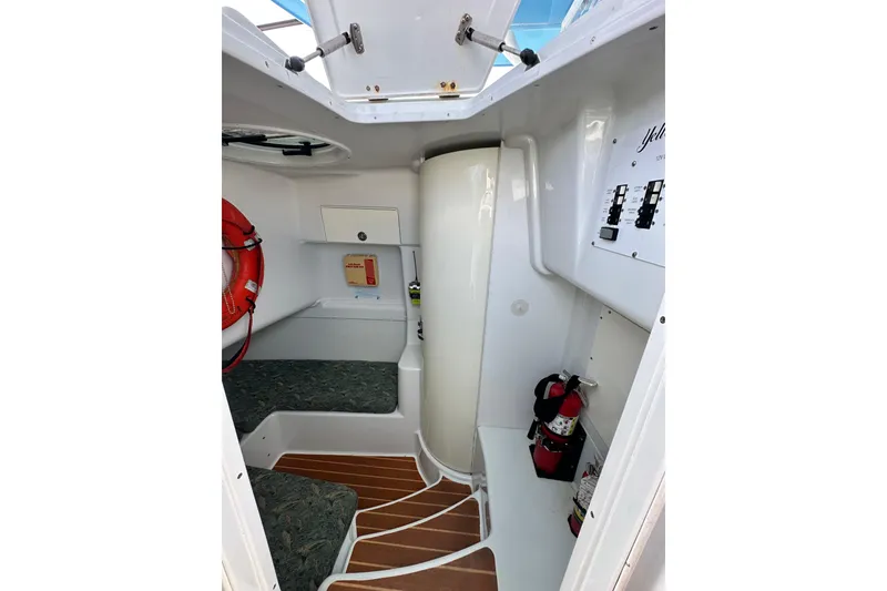 Slide: The Image of Interior cabin of 2009 Yellowfin 42 Offshore boat with seating, safety equipment, and control panel. - 59