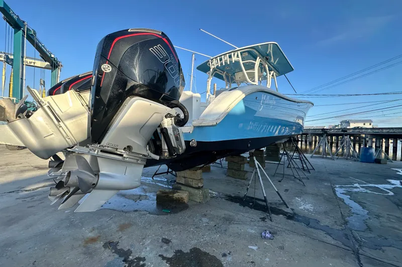 Slide: The Image of 2009 Yellowfin 42 Offshore boat with powerful outboard engines on a dock. - 6