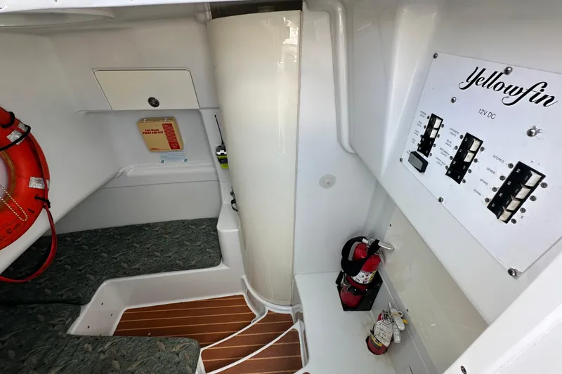 Slide: The Image of Interior of 2009 Yellowfin 42 Offshore boat with control panel and safety equipment. - 60