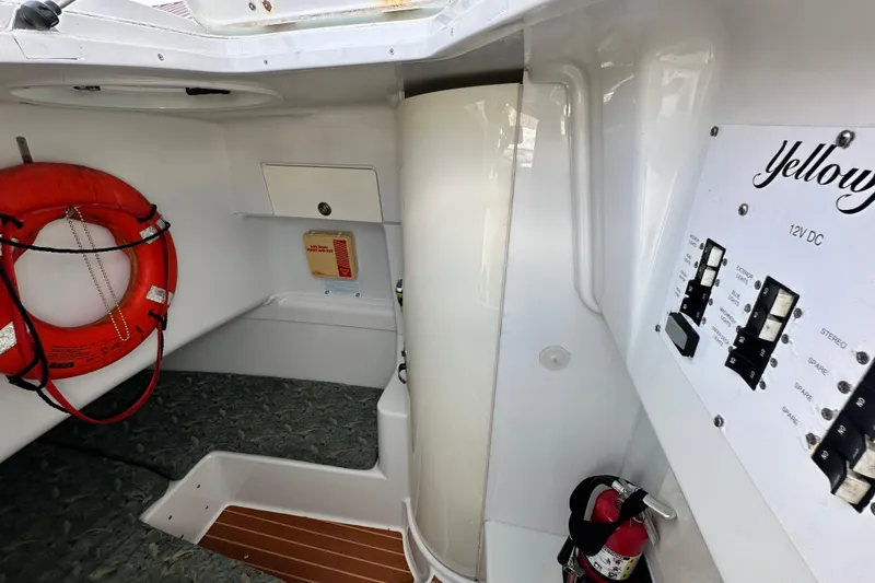 Slide: The Image of 2009 Yellowfin 42 Offshore interior with control panel, life preserver, and fire extinguisher. - 61