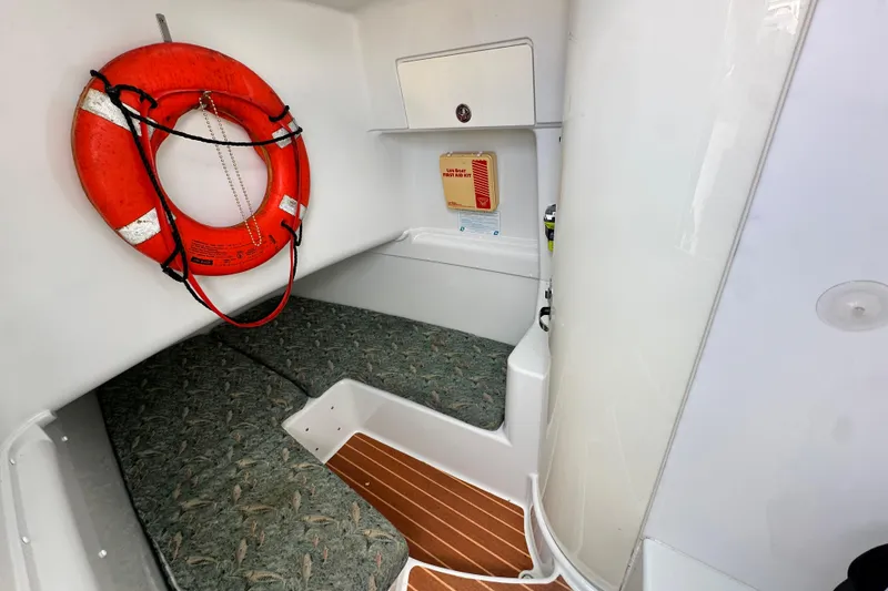 Slide: The Image of 2009 Yellowfin 42 Offshore cabin interior with life preserver and cushioned seating. - 62