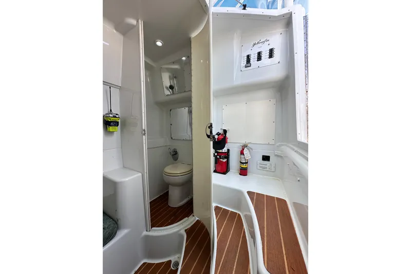 Slide: The Image of 2009 Yellowfin 42 Offshore boat interior with bathroom and safety equipment. - 67