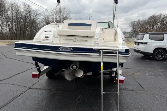 Slide: The Image of 2010 Chaparral Sunesta 244 boat, rear view with ladder, parked on asphalt. - 10