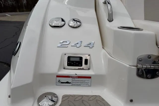 Slide: The Image of 2010 Chaparral Sunesta 244 boat dashboard with controls and model number. - 11