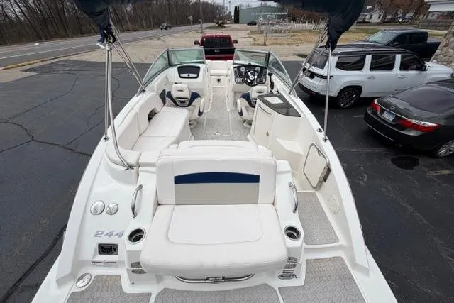 Slide: The Image of 2010 Chaparral Sunesta 244 boat with spacious seating and modern dashboard, parked outdoors. - 12