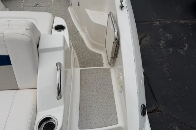 Slide: The Image of 2010 Chaparral Sunesta 244 boat interior with seating, cup holders, and non-slip flooring. - 13