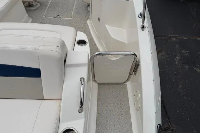 Slide: The Image of 2010 Chaparral Sunesta 244 boat interior with white seating and stainless steel accents. - 14