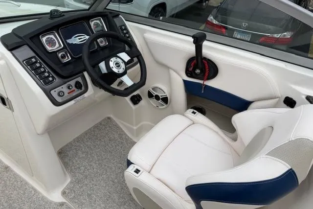 Slide: The Image of 2010 Chaparral Sunesta 244 boat cockpit with steering wheel and control panel. - 19