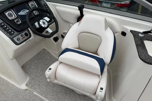 Slide: The Image of 2010 Chaparral Sunesta 244 boat cockpit with steering wheel and cushioned captain's chair. - 21