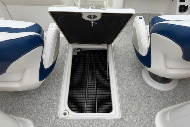 Slide: The Image of 2010 Chaparral Sunesta 244 boat interior with open storage compartment. - 27