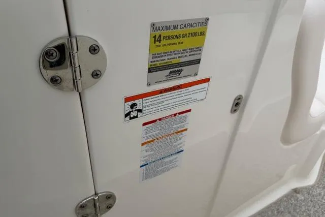 Slide: The Image of 2010 Chaparral Sunesta 244 capacity label, indicating a maximum of 14 persons or 2100 lbs. - 29