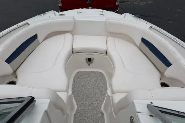 Slide: The Image of 2010 Chaparral Sunesta 244 boat interior with white seating and blue accents. - 30