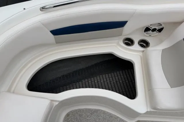 Slide: The Image of 2010 Chaparral Sunesta 244 boat interior with seating, cup holders, and speaker. - 31