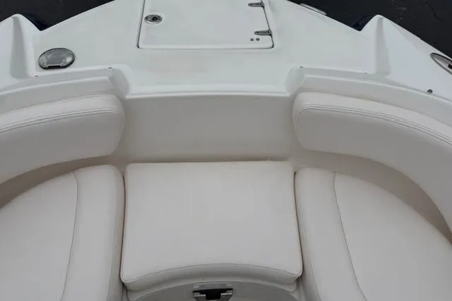 Slide: The Image of 2010 Chaparral Sunesta 244 boat interior with white cushioned seating. - 32