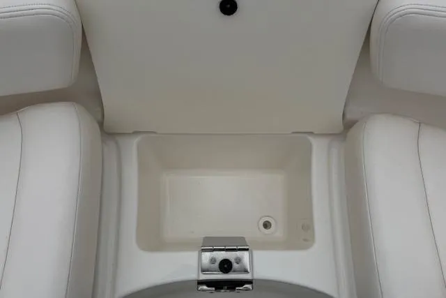 Slide: The Image of 2010 Chaparral Sunesta 244 boat interior with white seating and storage compartment. - 33